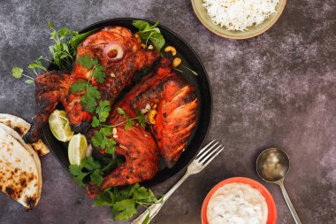 Tandoori Chicken whole with naan, raita and pilau rice, top view, blank space clipart