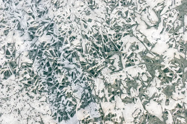 Texture of frozen water. Transparent ice crystals crack texture, background.