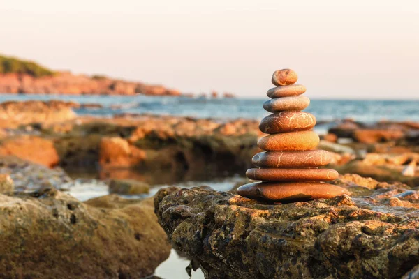 Balance and harmony. Pebbles stacked in a pyramid on the coast of the sea in nature.