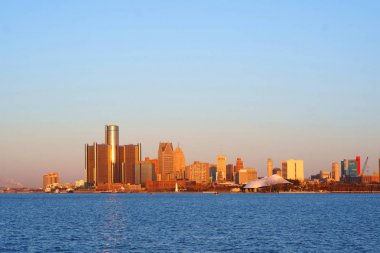 Downtown Detroit view from Belle-Isle during sunrise with view on Bridge to Windsor, Ontario, Canada.                                clipart