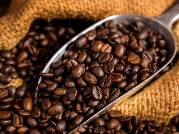 Coffee bean with bag and spoon on wood background — Stock Photo, Image