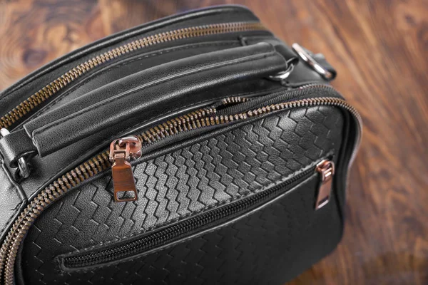 broken zipper on a woman\'s bag