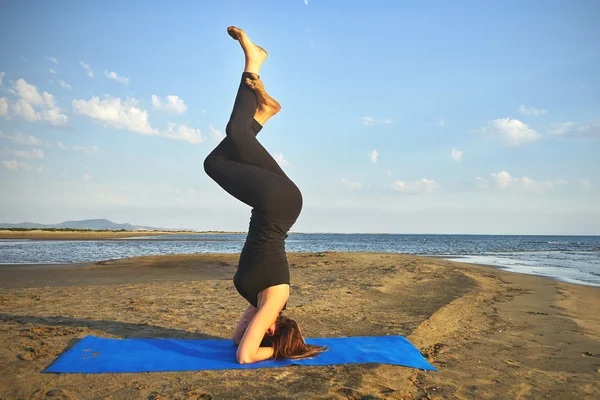 Young Woman Practicing Yoga On The Beach By The Ocean, Yoga Poses Set  Against Beautiful Background Stock Photo | Adobe Stock
