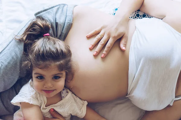 Mooie zwangere vrouw en haar schattige kleine dochter samen ik — Stockfoto