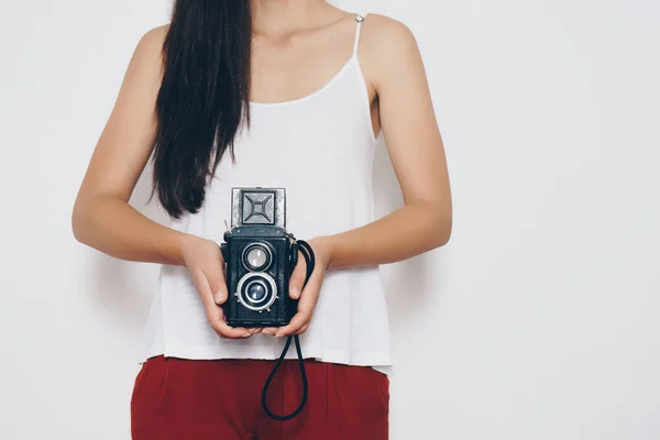 Woman holding a vintage camera front a white background — Stock Photo, Image