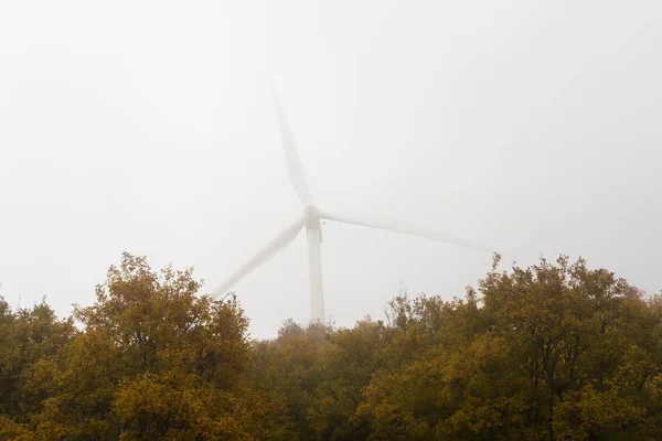 Wind power generator in  fog — Stock Photo, Image