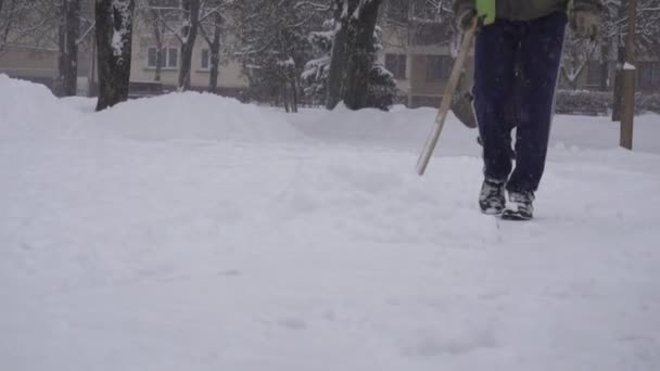 Homem zelador vai matar neve na cidade, tempestade de neve BOBRUISK, BELARUS - JANEIRO 14, 2019 — Vídeo de Stock