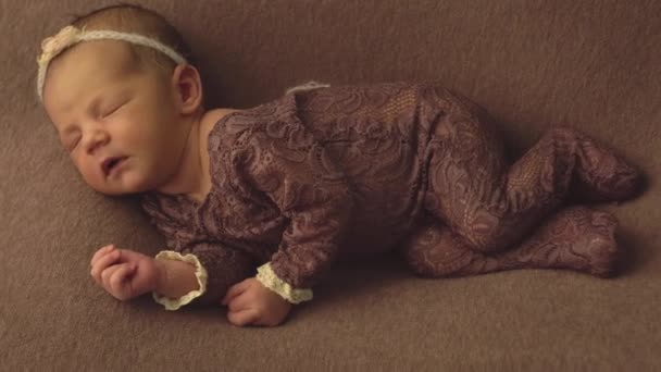 Mała piękna kaukaski dziewczyna w eleganckich ubrań śpi w studiu i stwarza dla sesji zdjęciowej, niemowlę — Wideo stockowe