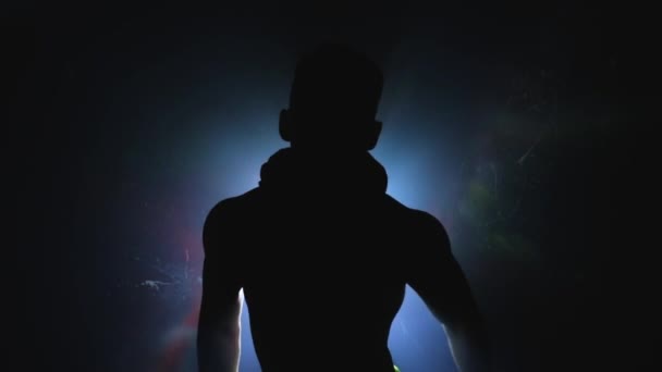 Man choreographer dances Striptease in silhouette in slowmo. Private erotic dance with torso. Male sexual body movements. Hot muscular stripper like a macho shows performance alone. Background light — Stock Video