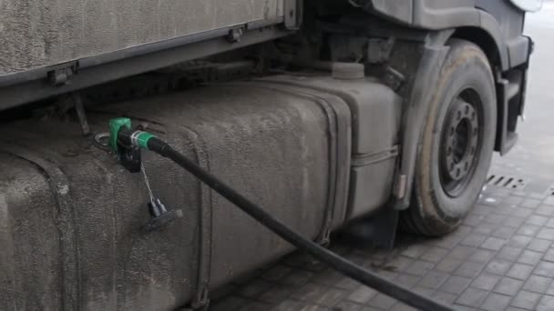 Refueling a dirty road train with diesel fuel. Road reagents. Fuel consumption on the highway, industry, autotruck — Stock Video