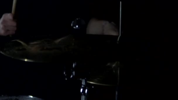 A male musician plays on a drum kit with drumsticks at a concert, a large plan, background. Slow motion, rocker — Stock Video