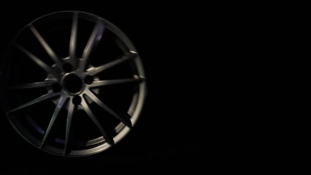 Car metal disc on a black background rolls into the frame, place for an inscription, rims — Stock Video