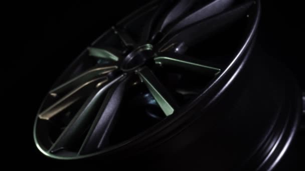 Modern automotive alloy wheel made of aluminum on a black background, industry. Designer fashion wheels for car, mechanic, copy space — Stock Video