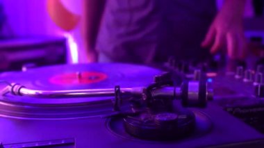 DJ bir gece kulübü partisinde kumandayı aktif olarak kontrol eder, gençlik dansı, arka plan, denetleyici