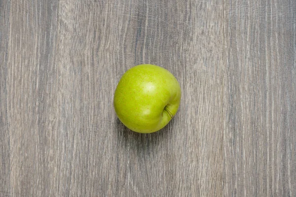 Яблоко на деревянном столе — стоковое фото