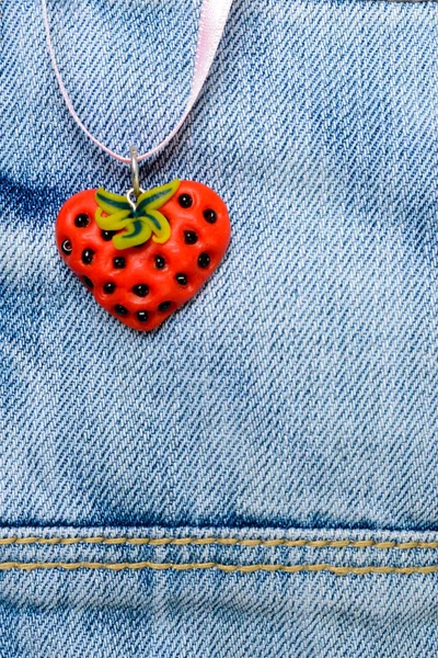 Strawberry heart on jeans — Stock Photo, Image