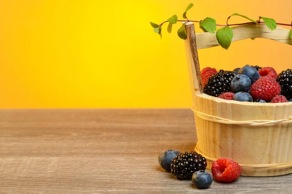 Wooden basket with berries — Stock Photo, Image