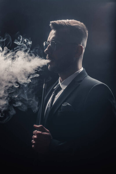 Fashionable man smokes