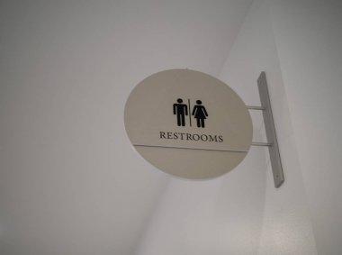 Women/men steel, modern restroom sign hanging high clipart
