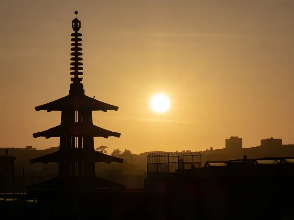 Silhouette of Peace Pagoda in San Francisco, CA while sun is set