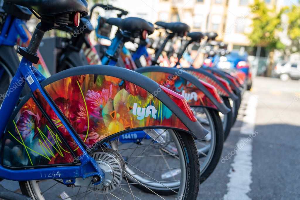 San Francisco, CA OCTOBER 5, 2019: Row of Lyft Bikes sitting at bikeshare docking station in parking lot on street