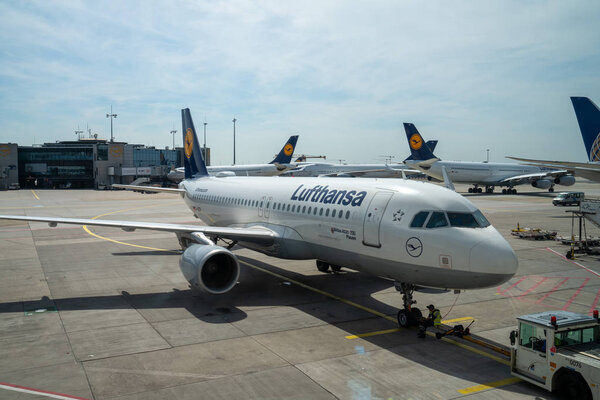 Lufthansa aircraft pulling into boarding area at terminal