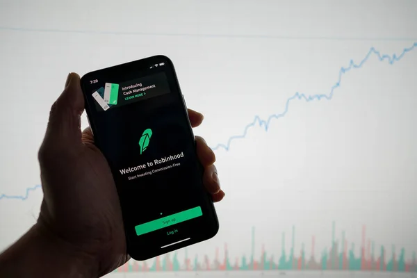 San Francisco, California February 09, 2020: Robinhood app on phone with white financial stock chart with price rising upward positive in background — Stock Photo, Image