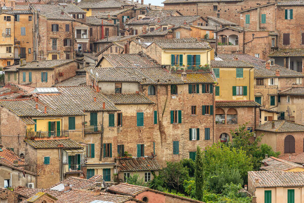 Pattern houses beackground, Old residential houses in medieval city of Siena, Italy