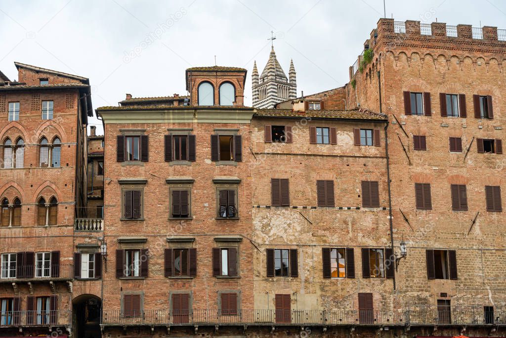 Ancient houses in the old piazza in town siena, italy