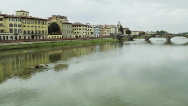 Remo solitario en el río Arno entre puentes al atardecer en Florencia — Vídeo de stock