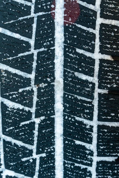 Mud and snow tire tread packed of car with snow. Texture and background
