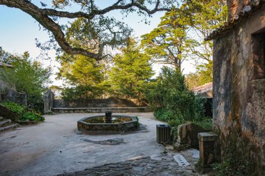 Ancient fountain and stone building. Convent of the Capuchos in Sintra, Lisbon Region, Portugal clipart