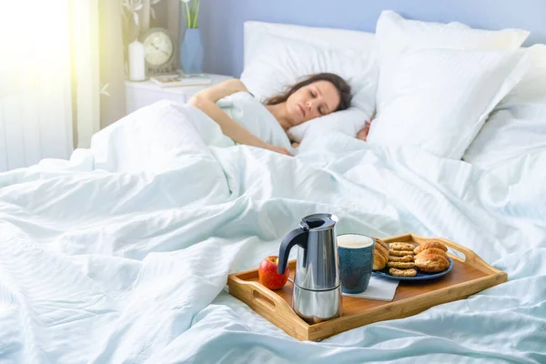 Happy attractive woman wake up in the morning in bed. Good morning and fresh and beautiful breakfast on tray for the girl