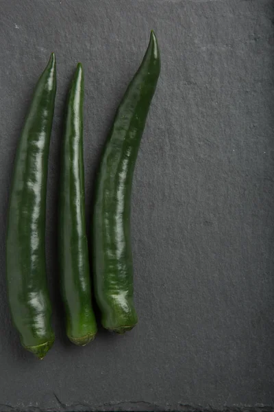 Zielona papryka chili na ciemnym tle — Zdjęcie stockowe