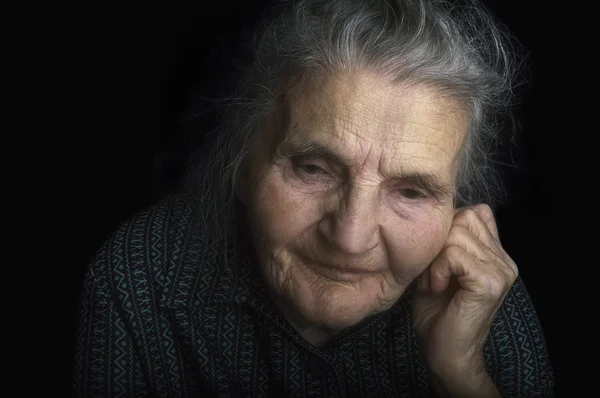 Portrait of a sad elderly woman. Dreaming the past. — Stock Photo, Image