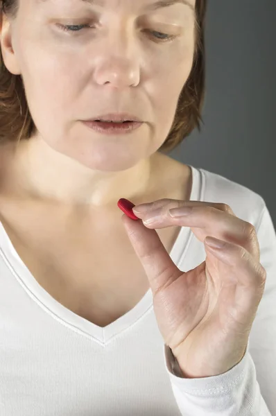 Close up of woman taking in pill. — Stock Photo, Image
