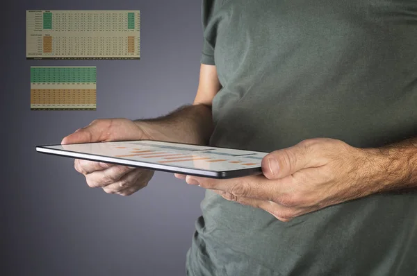 Man hand holding a modern tablet with financial graph. — Stock Photo, Image