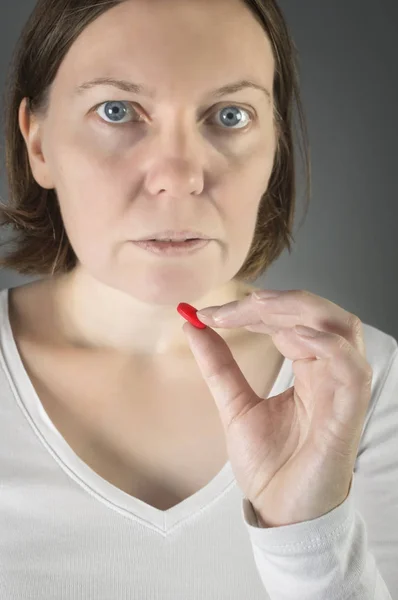 Close up of woman taking in pill. — Stock Photo, Image