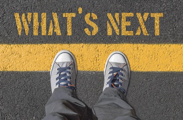 WHAT`S NEXT print with sneakers on asphalt road. — Stock Photo, Image