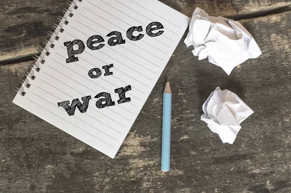 평화 또는 전쟁 텍스트 펜으로 노트북에 구겨진 종이. — 스톡 사진
