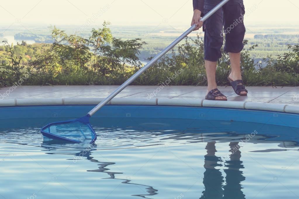 Man cleaning swimming pool
