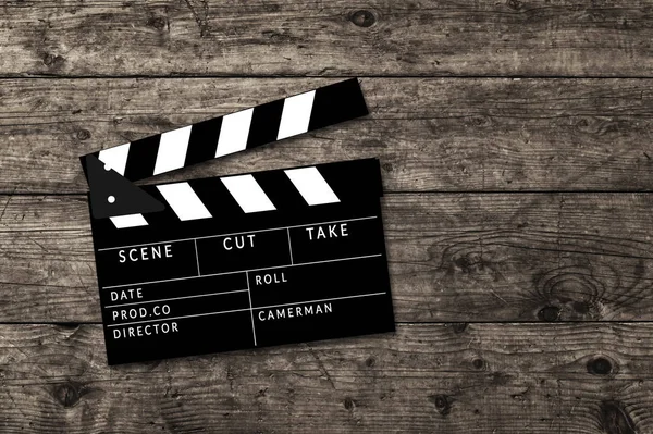 Movie clapperboard on wooden table background. — Stock Photo, Image