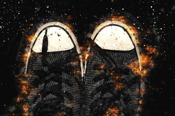 Turnschuhe in Flammen isoliert auf schwarzem Hintergrund — Stockfoto