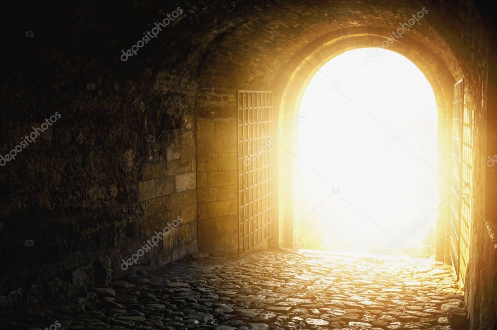 Door to Heaven. Arched passage open to heaven`s sky. Light at en