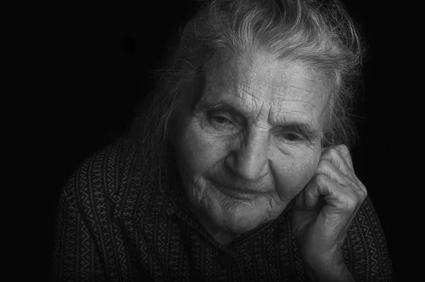 Portrait of a sad elderly woman. Dreaming the past. — Stock Photo, Image