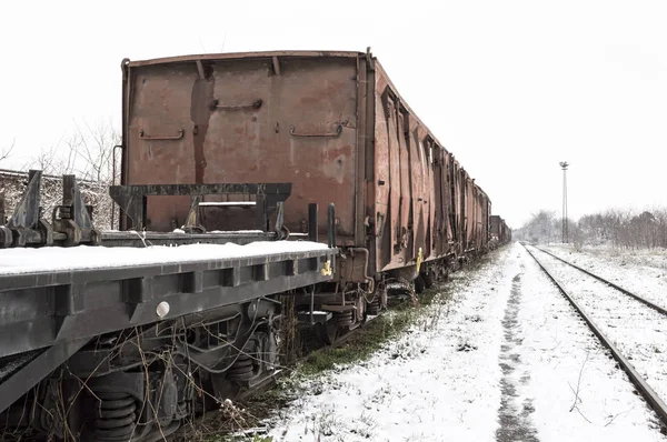 Vagões velhos na estrada de ferro na neve no inverno . — Fotografia de Stock