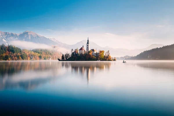 Amazing view on a misty morning of lake Bled with St. Marys Church of the Assumption on the small island; Bled, Slovenia, Europe.