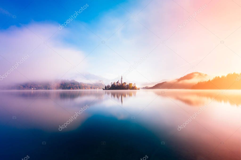 Amazing view on a misty morning of lake Bled with St. Marys Church of the Assumption on the small island; Bled, Slovenia, Europe.