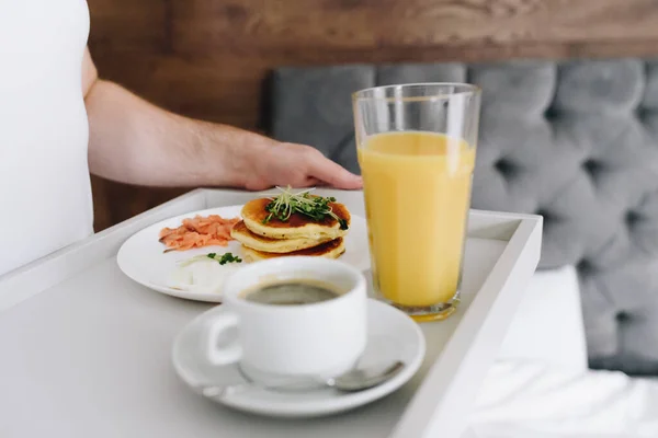 Caucasian man hands, bringing tasty breakfast to bed on tray — 스톡 사진