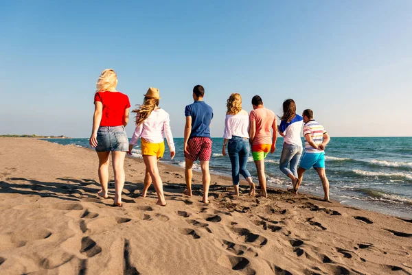 Summer holidays, vacation and beach activities - friends on the beach